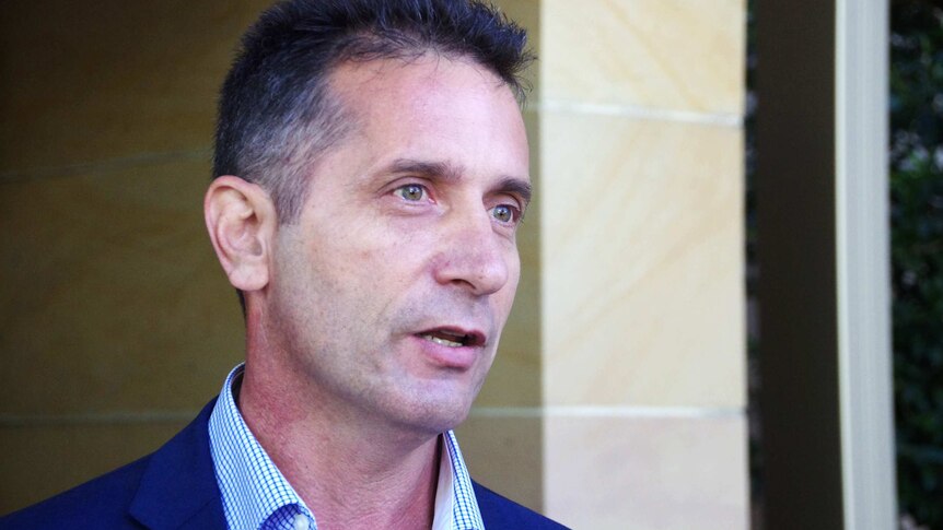 A tight shot of Paul Papalia speaking into a microphone during a TV interview outside State Parliament.