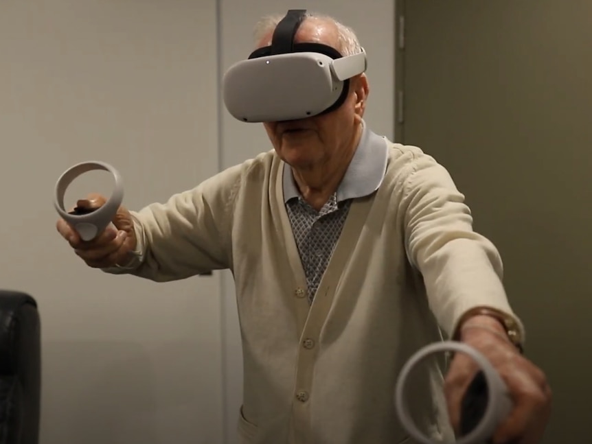 An older man plays a virtual reality game. 