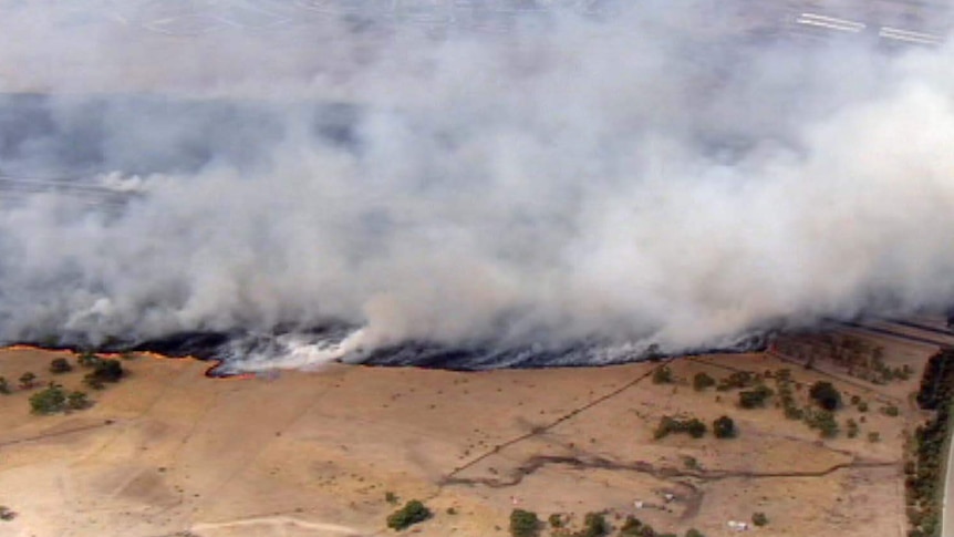 A grassfire burns near the Hume Highway