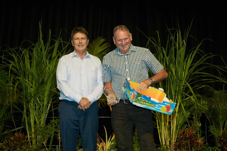 David Hoseason-Smith (right), receiving an innovation award from NT Farmers' president Simon Smith.