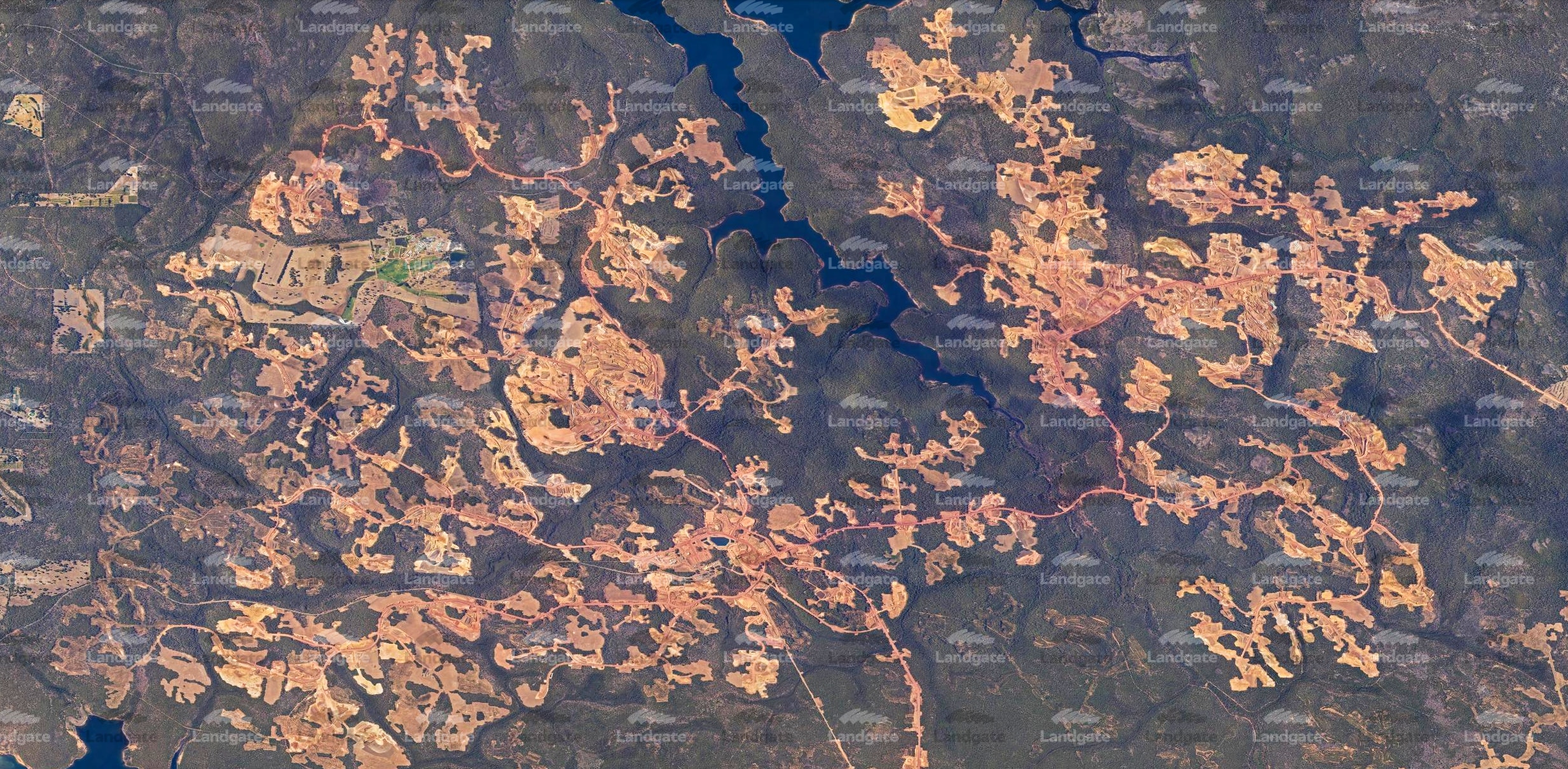 An aerial shot of a sprawling mine in a forest