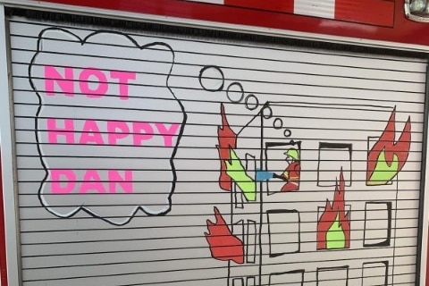 firetruck emblazoned with slogan that reads not happy dan