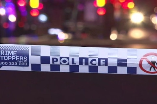 Blue and white police tape in front of traffic accident scene