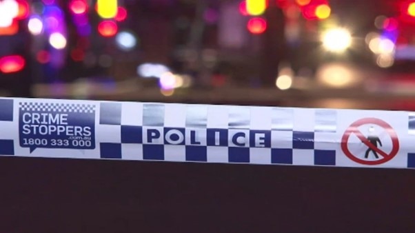 Blue and white police tape in front of an incident scene