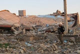 A member of the Iraqi security forces stands in the rubble of destroyed buildings in Ramadi.