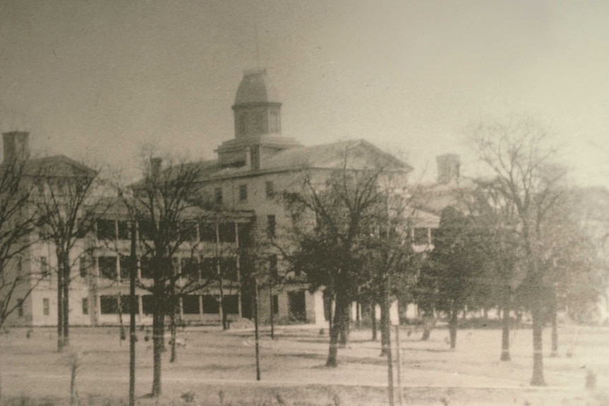 Black and white file photo of the large asylum building.