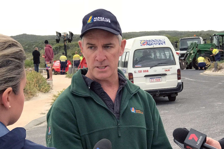 The department's Ben Tannock speaks to the media about the clean up of whale carcacces.