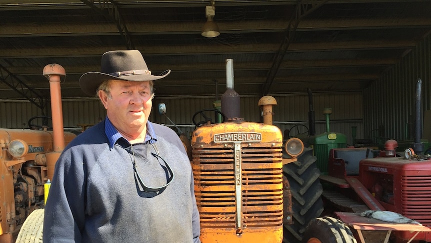 Bill Shanley standing in front of orange tractor