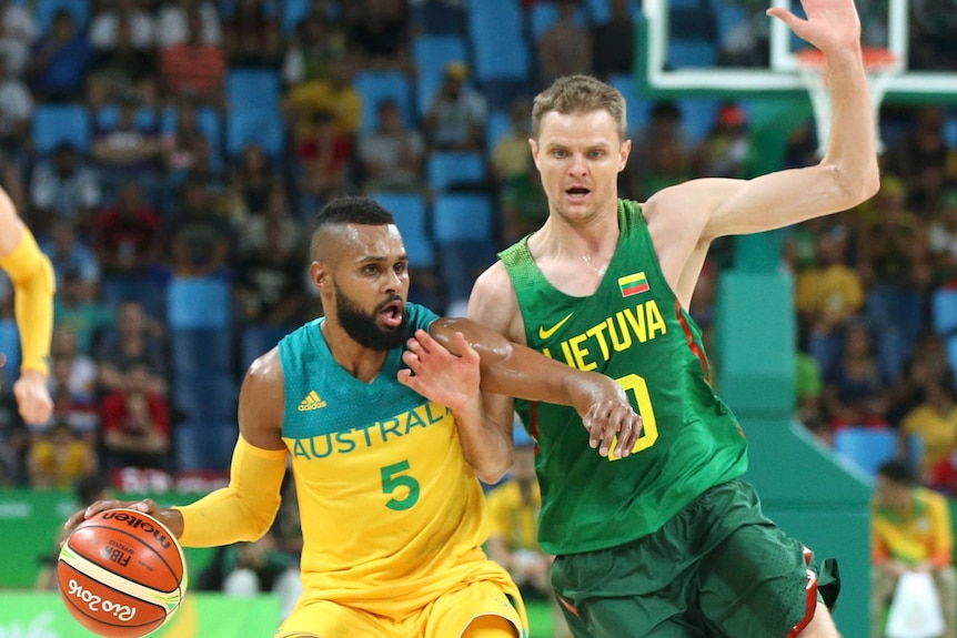 Patty Mills of Australia and Renaldas Seibutis of Lithuania