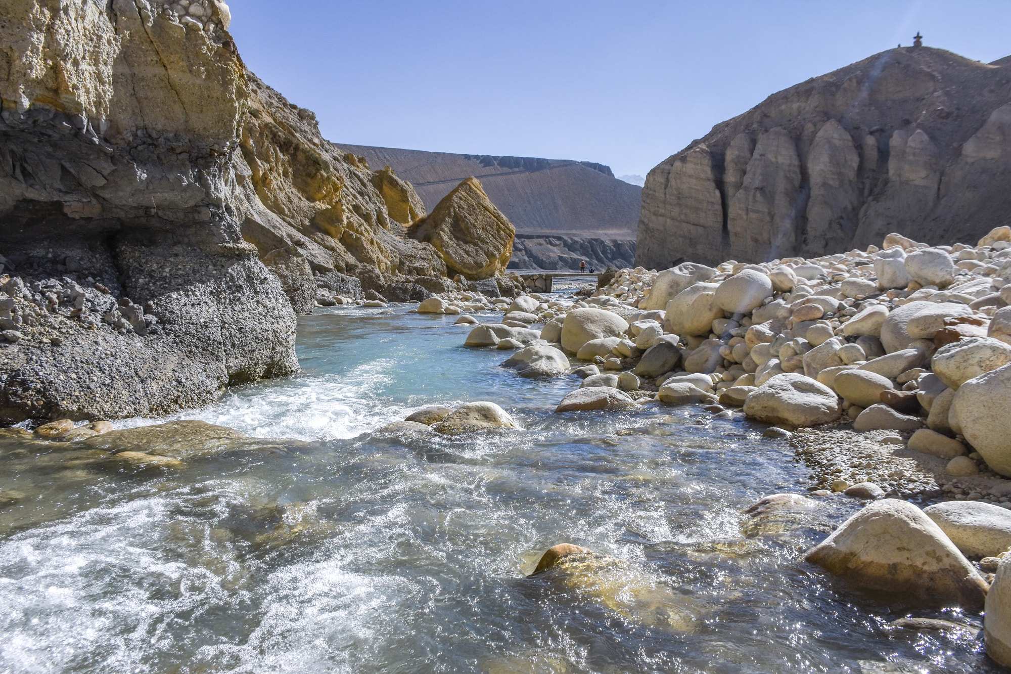 A beautiful blue river winding through boulders