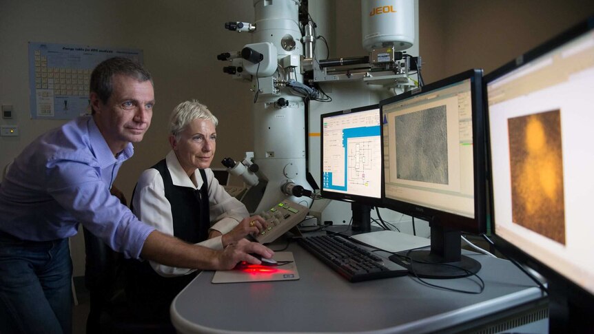 Dr Andrea Borsato and Associate Professor Silvia Frisia look at images of the calcite found in Antarctica.