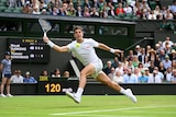Australia's Thanasi Kokkinakis eyes the ball as he stretches out to get his racquet to the ball on Centre Court at Wimbledon.