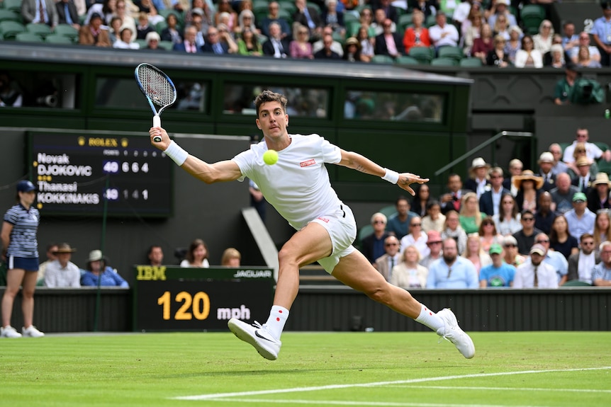 Australia's Thanasi Kokkinakis eyes the ball as he stretches out to get his racquet to the ball on Centre Court at Wimbledon.