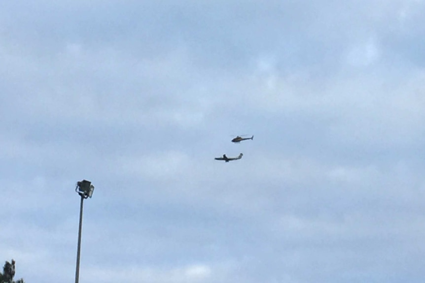 Police plane and helicopter in skies above Adelaide.