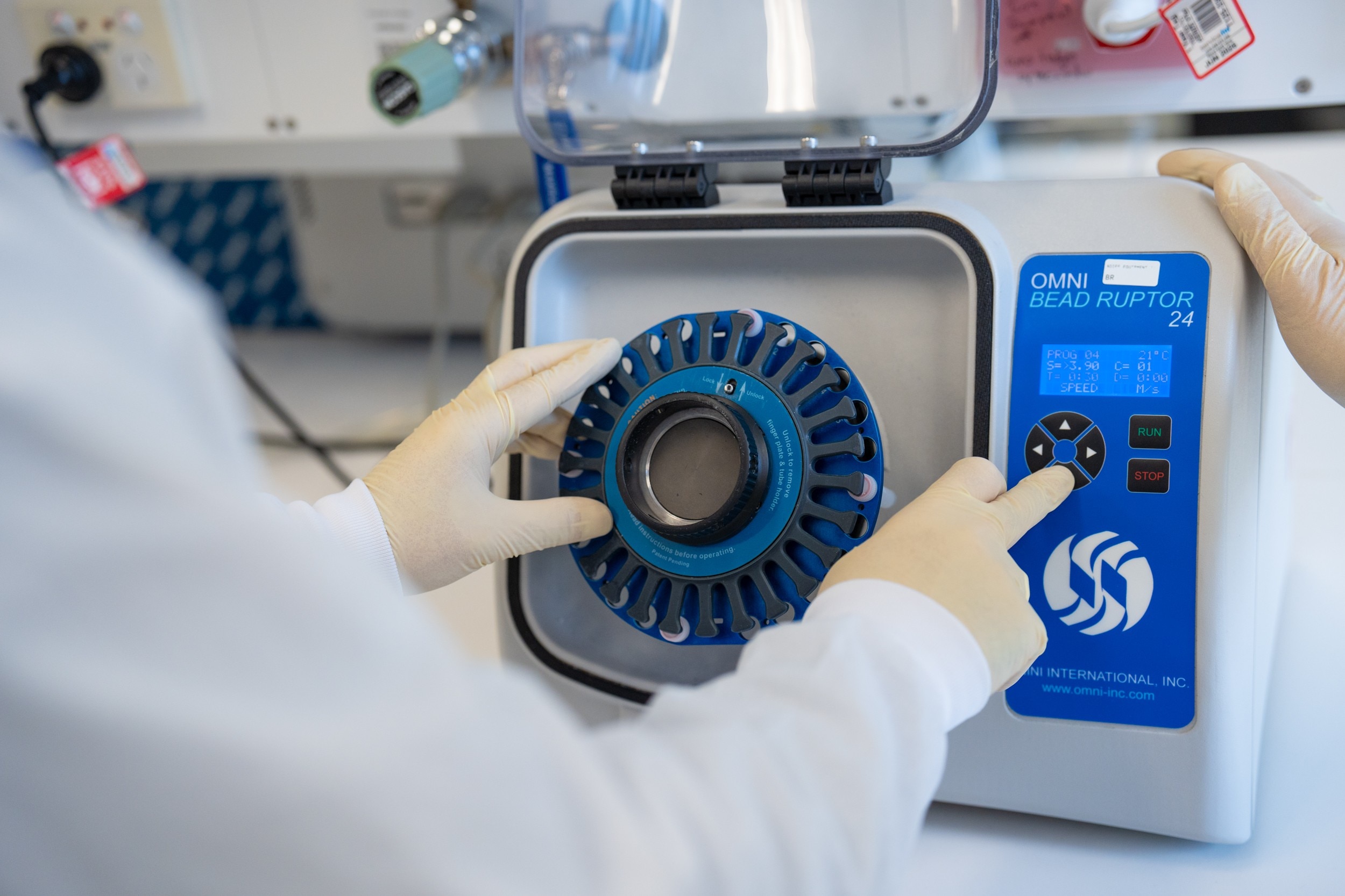 A person operating a piece of laboratory equipment. 