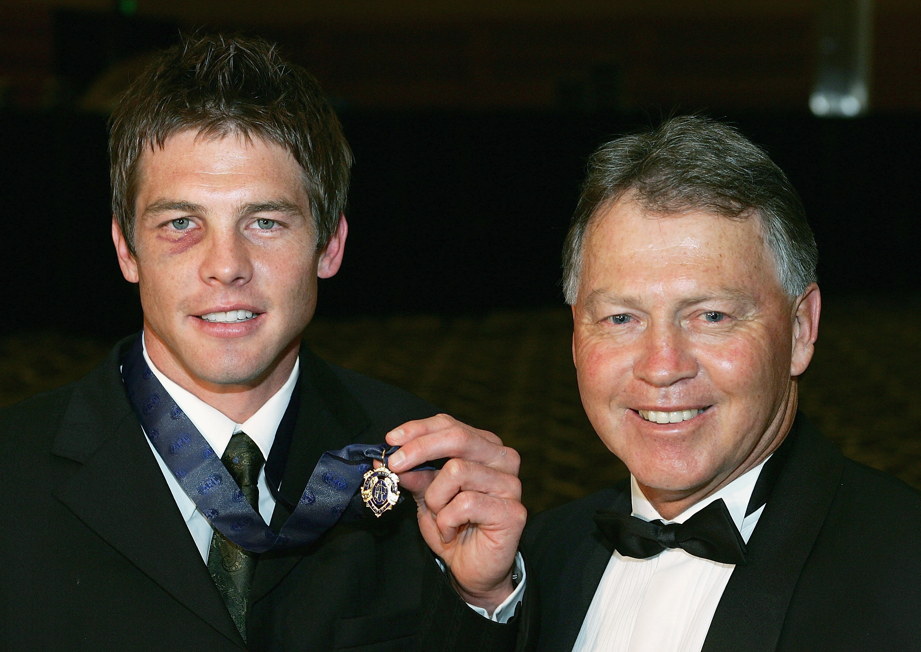Ben Cousins stands next to his father Bryan Cousins with the 2005 Brownlow medal.