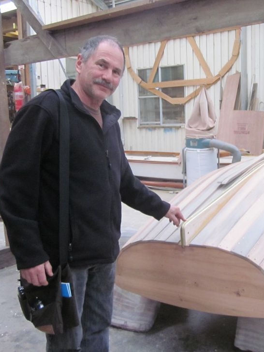 Man next to boat in workshop