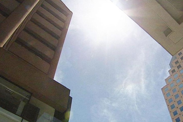 sun glare above city buildings