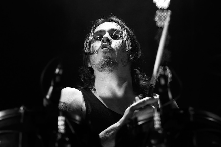 Black and white shot of man playing drums