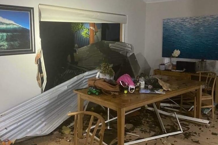 Shattered glass covers the floor of the kitchen.