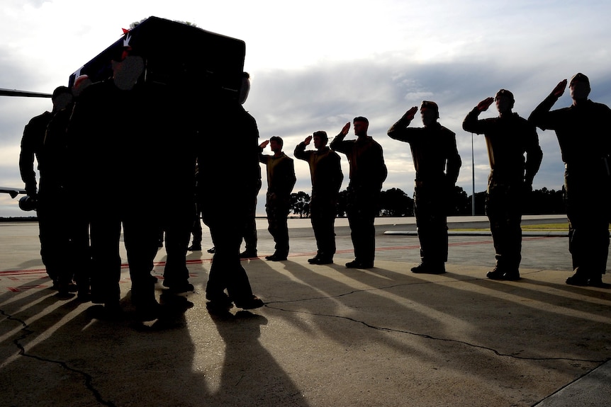 SAS soldiers salute Sgt Blaine Diddams' casket at RAAF Base Pearce, WA