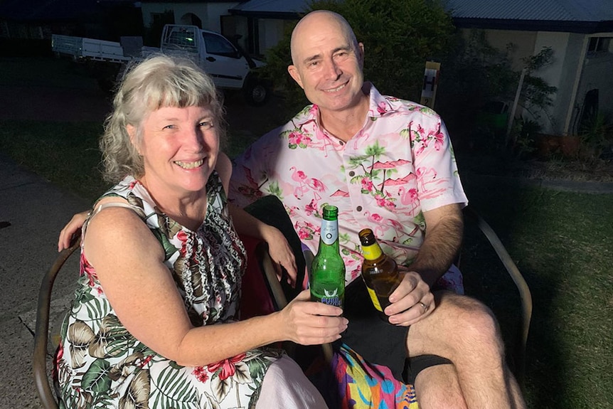 Andrea Volling and Alan Znojemsky, sit in chairs in the driveway of their home in Ipswich, west of Brisbane.