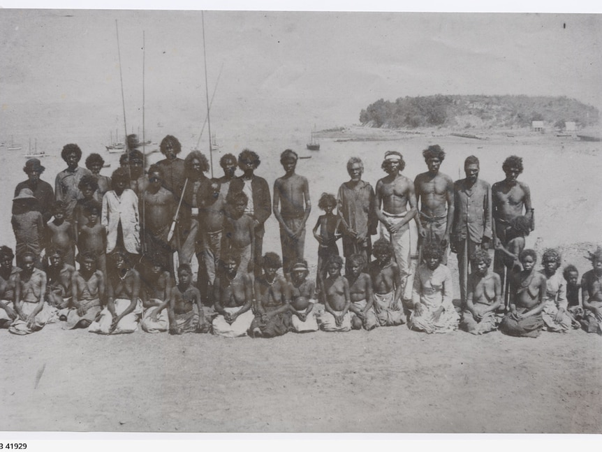 Aborigines grouped on Dinah Beach, Stokes Hill in background.