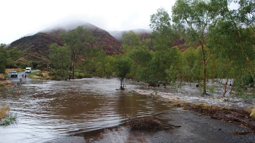 Water across one part of the road into Ormiston Gorge, in Central Australia.