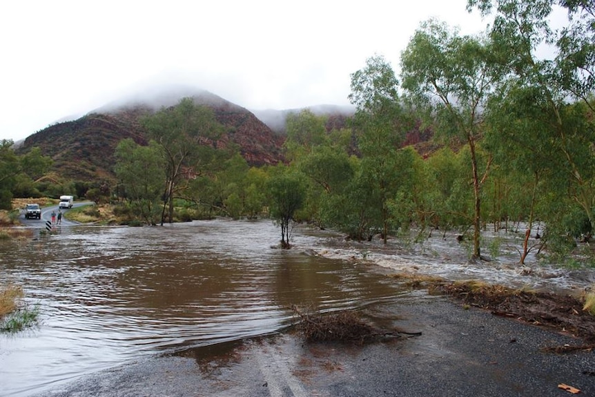 Water across one part of the road into Ormiston Gorge, in Central Australia.