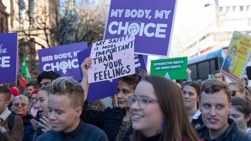 safe abortion rights rally with signs including one that reads 'my body my choice'