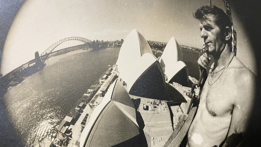 Man high above Sydney Opera House.