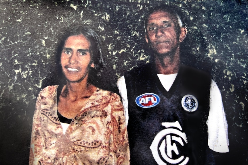 Veronica Nelson smiles as she poses for a photo with Percy Lovett, who is wearing a Carlton footy jumper.