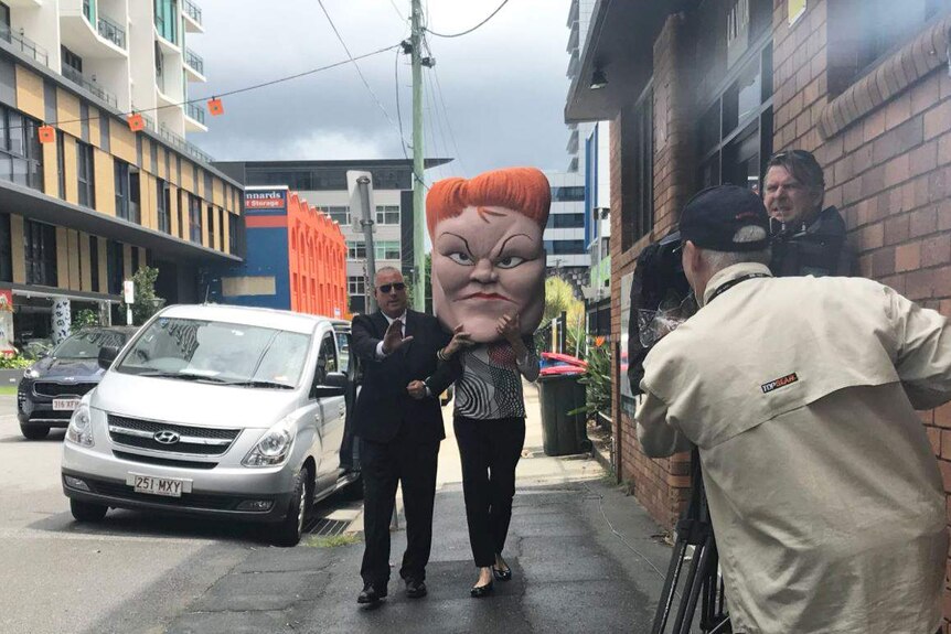 A protester in a Pauline Hanson costume outside the LNP's launch of its 2017 state election.