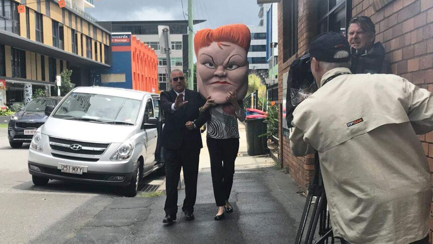 A protester in a Pauline Hanson costume outside the LNP's launch of its 2017 state election.