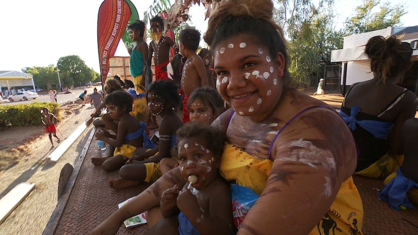 Indigenous people with faces painted at Boab Festival Mardi Gras float parade