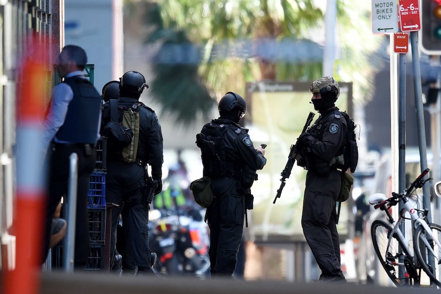 NSW Public Order and Riot Squad Police gather outside the Lindt Chocolat Cafe in Martin Place.