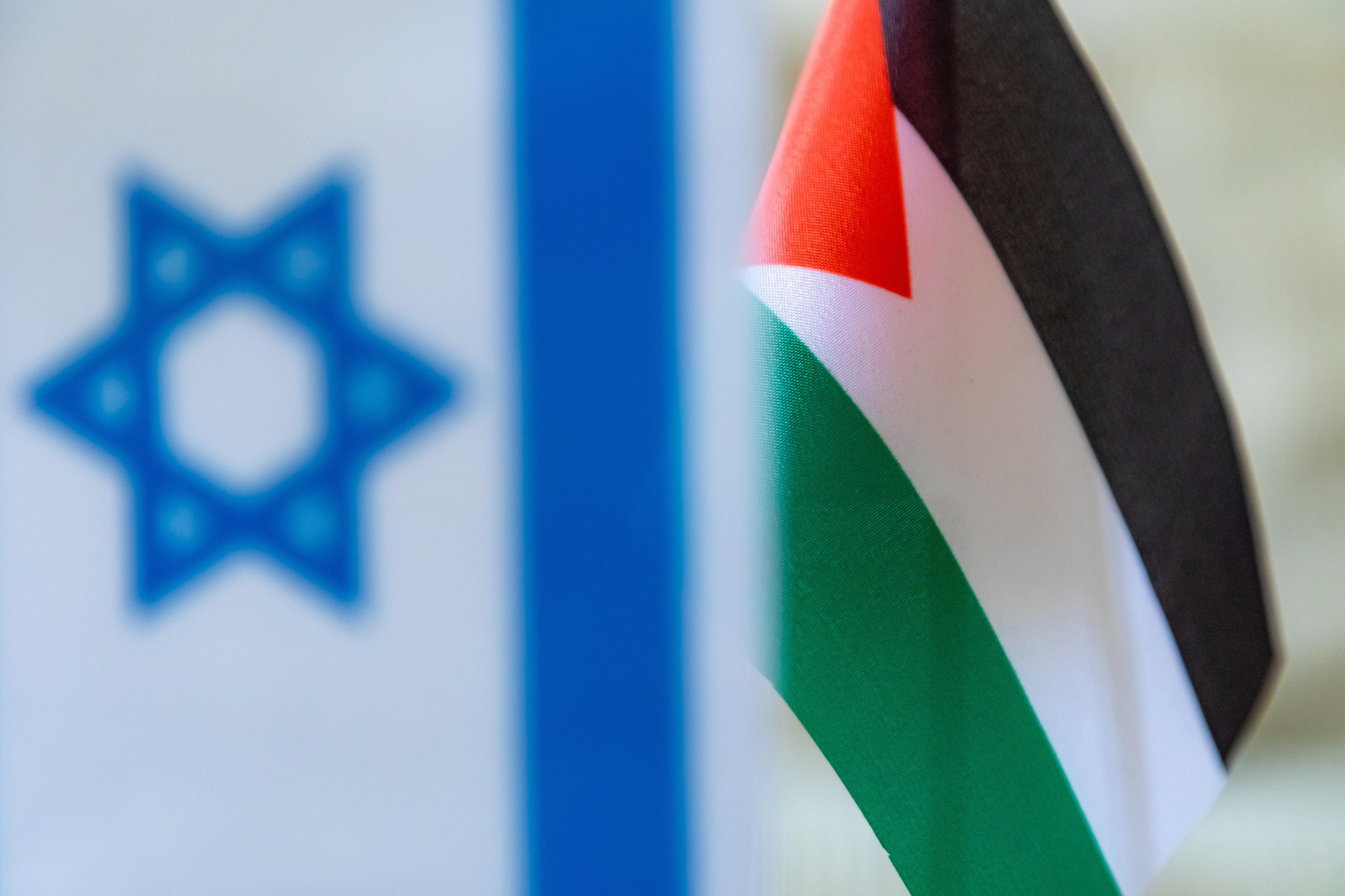 An Israeli flag and a Palestinian flag flying together