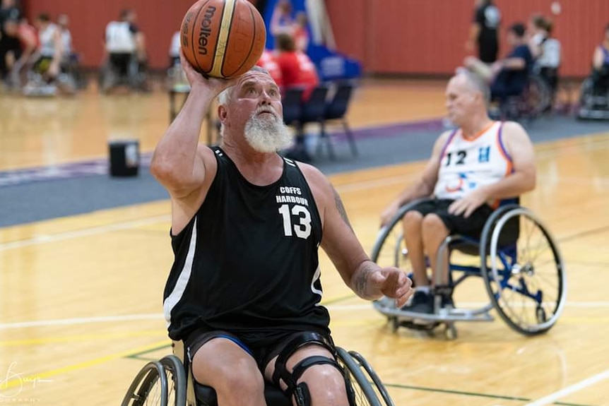 Robert Piper shooting a goal in wheelchair basketball competition