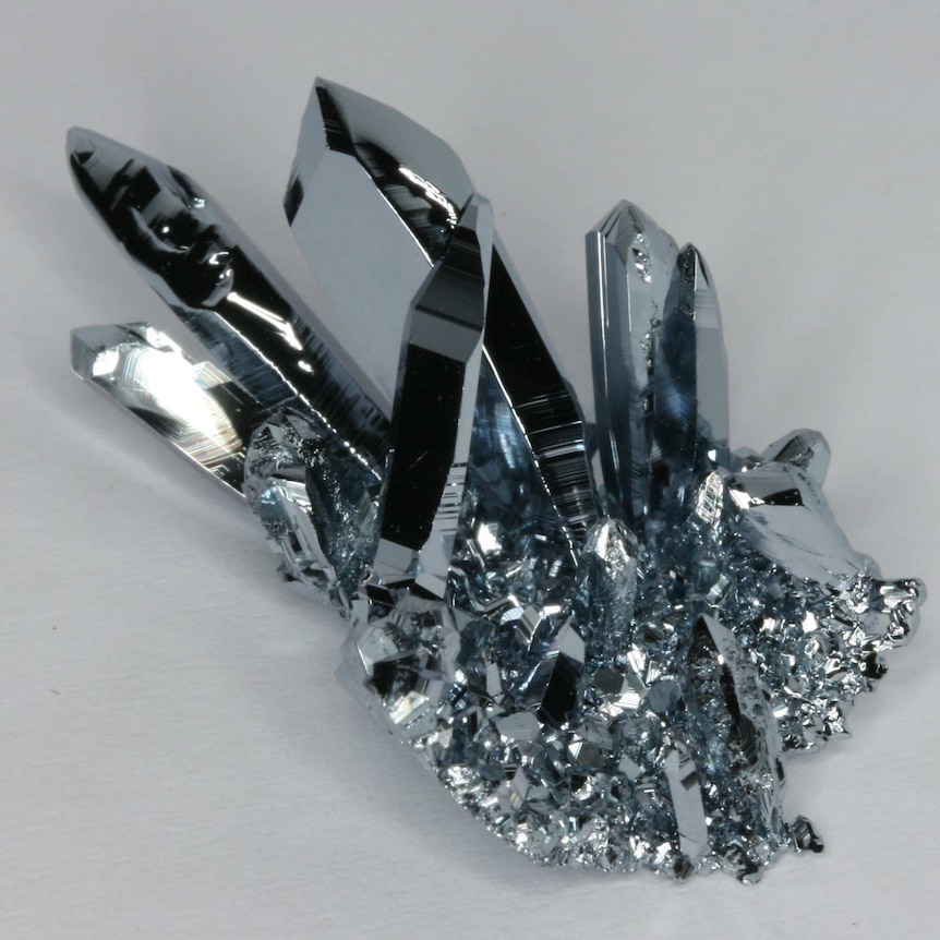 A cluster of bright silver-coloured crystals.