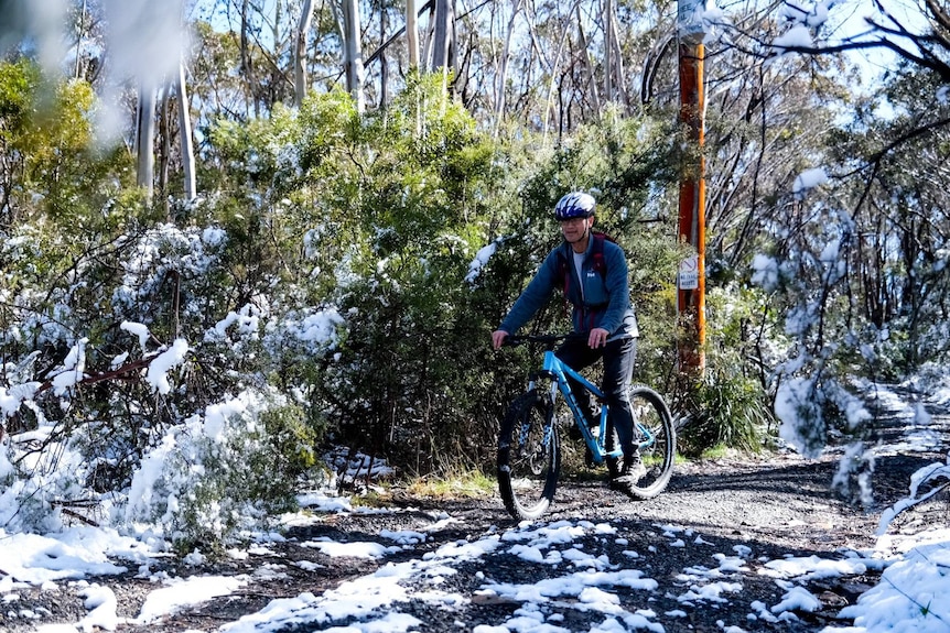 A cyclist on a road in snow