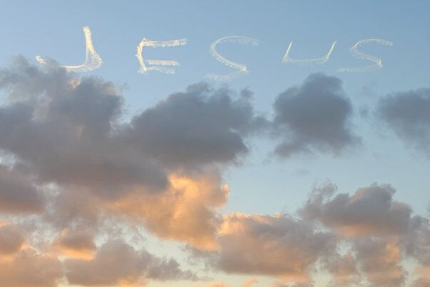 A skywriter adds 'Jesus' to the sunset panorama in Sydney