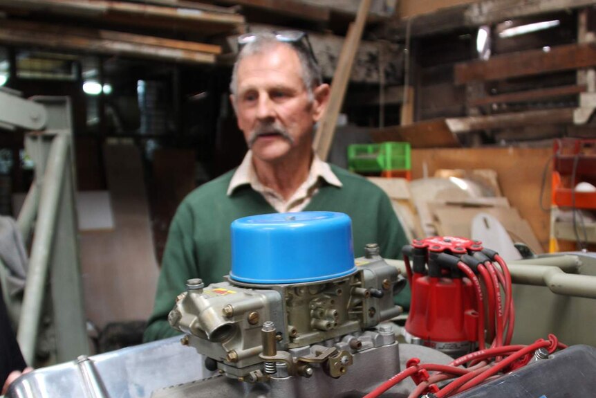 Rood McNeill stands behind a motor he has made