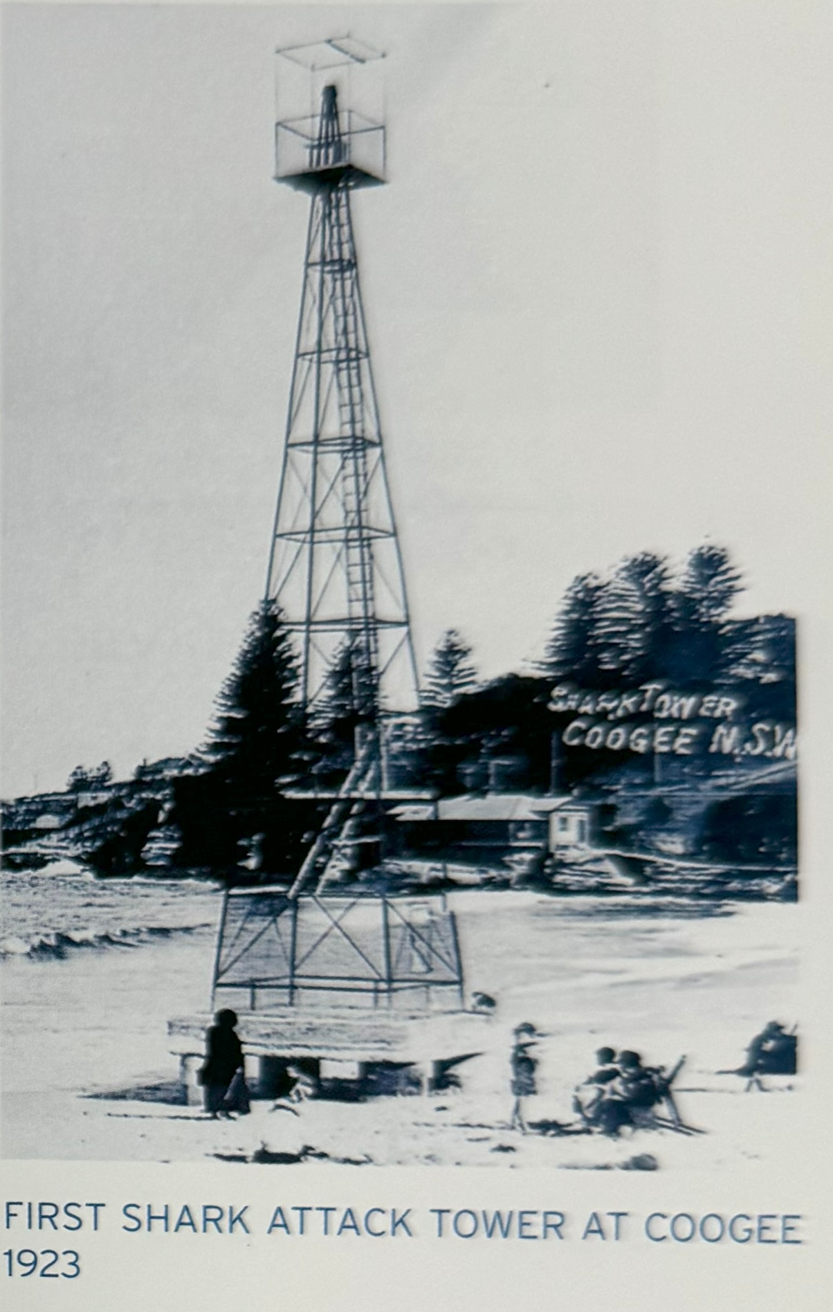 the frame of a triangular pole tower on a beach