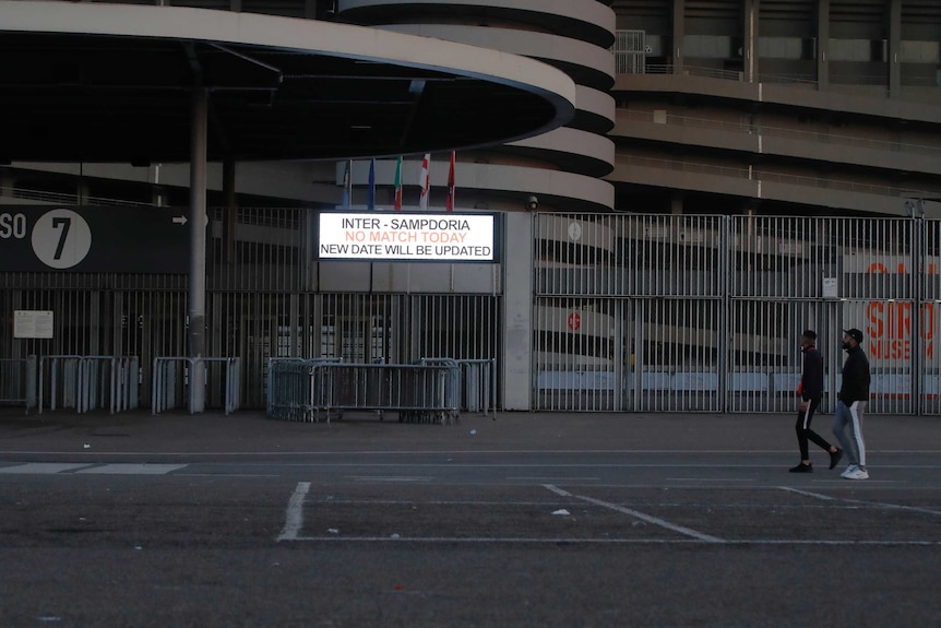 A sign outside an empty stadium says: "Inter-Sampdoria No Match Today New Date Will Be Updated".