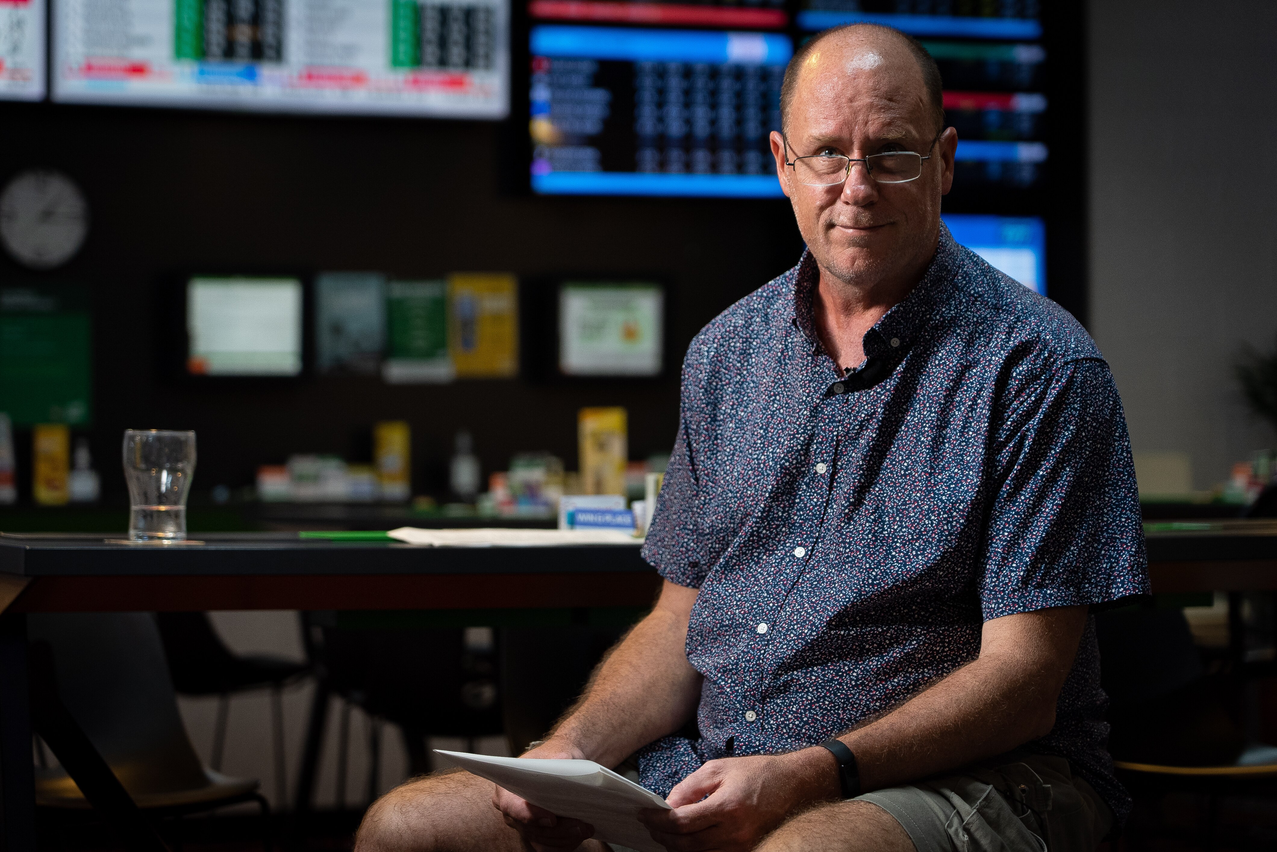 A man sits on a chair looking serious