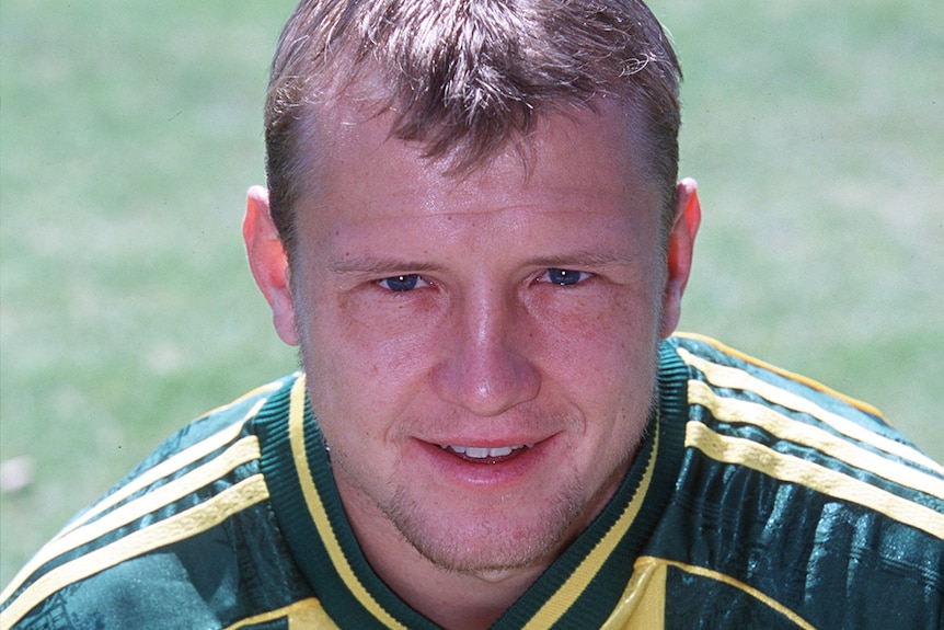 A profile of former Socceroo Stephen Laybutt in his playing kit smiling