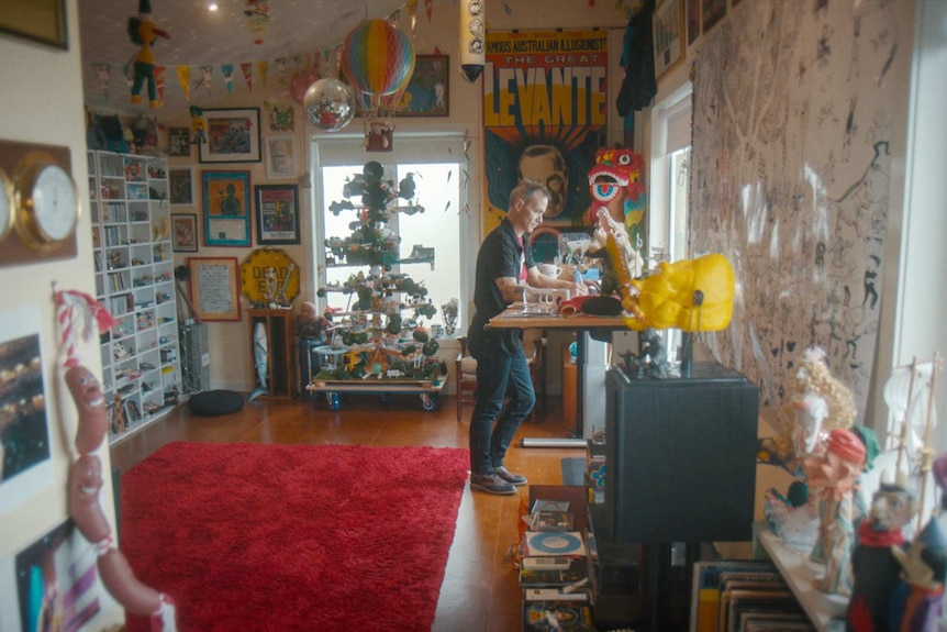 Griffiths writing in a colourful and clutter studio