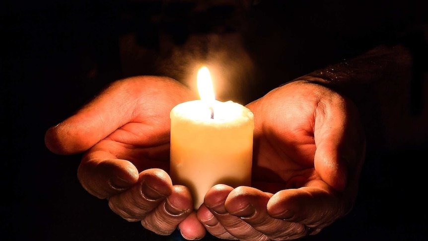 Holding a candle using hands