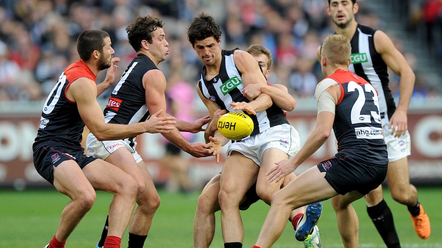 Collingwood's Scott Pendlebury is tackled by Melbourne's Jack Viney at the MCG in June 2014.