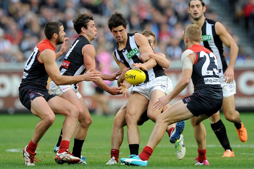 Collingwood's Scott Pendlebury is tackled by Melbourne's Jack Viney at the MCG in June 2014.